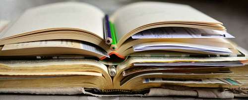 primer plano de un par de libros con lápices como guardapáginas