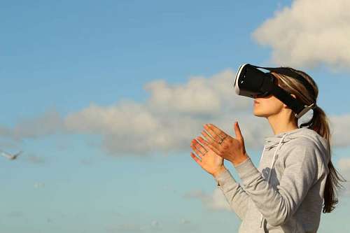 mujer utiliza VR al aire libre con el cielo de fondo