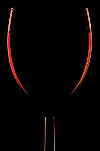 alcohol Silueta de una copa de vino tinto sobre fondo negro