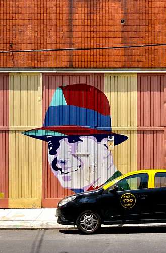 cortar Mural de Carlos Gardel frente a un Taxi en Buenos Aires, Argentina
