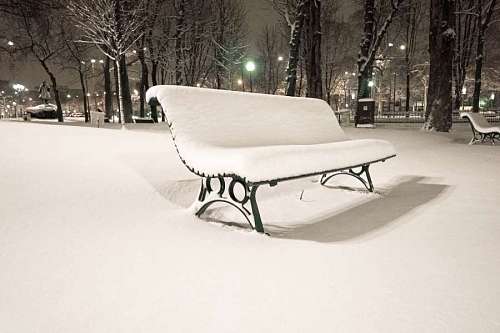 parque Banco en el parque cubierto de nieve
