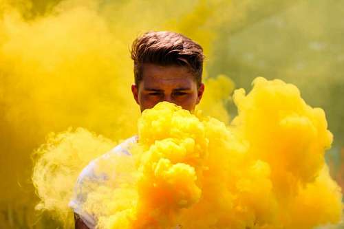 bombo Retrato de hombre entre bomba de humo color amarillo 